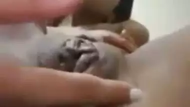 An Indian nude girl fingers her shaved pussy and ass